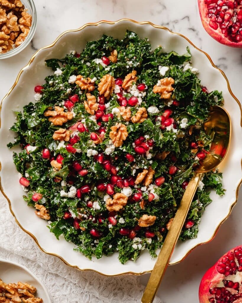 Christmas Kale Salad with Goat Cheese, Pomegranate Seeds, and Candied Nuts Recipe