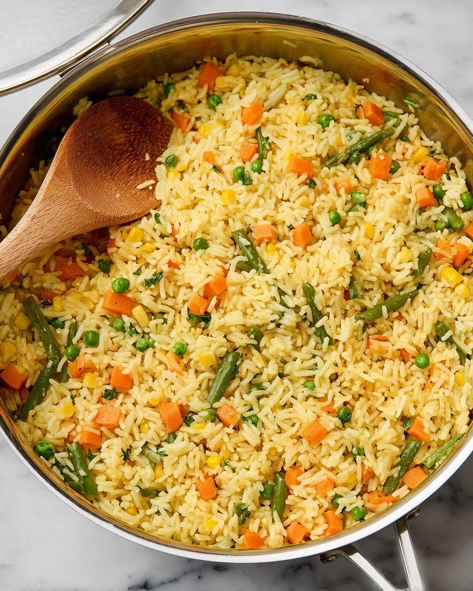 A deep pan filled with cooked yellow rice mixed with small diced orange carrots, green peas, chopped green beans, and light yellow corn kernels, all evenly distributed throughout the dish. A wooden spoon is partially submerged in the rice on the left side, and the pan has a shiny silver rim with part of its clear lid resting on the edge, reflecting some light. The pan sits on a white marbled surface. photo taken with an iphone --ar 4:5 --v 7