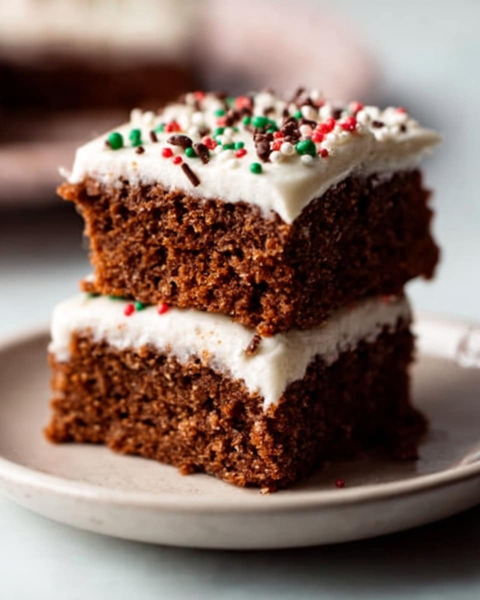 Two square pieces of a brown cake stacked on a white plate, each piece topped with a thick layer of white icing. Colorful tiny sprinkles and small orange star-shaped decorations are scattered on the icing. The cake looks moist with a slightly rough texture. The background is a white marbled texture, with soft natural light giving a warm feel. photo taken with an iphone --ar 4:5 --v 7