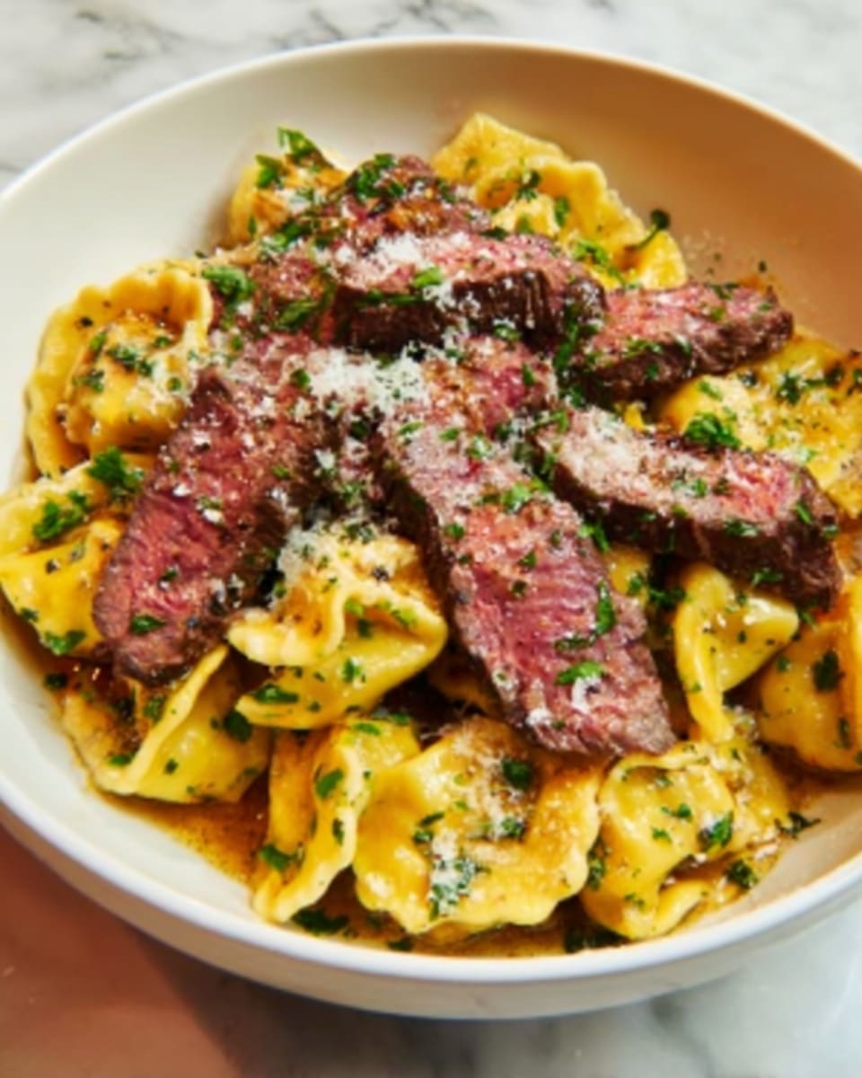 A white bowl filled with a rich and colorful dish featuring multiple layers: at the base are golden yellow stuffed pasta pieces with edges folded over, topped with medium-rare steak slices showing a pink center and darkened edges, all mixed together and garnished with finely chopped bright green herbs and sprinkled with white grated cheese. The contrast between the pasta and the steak highlights texture differences, with the pasta appearing soft and the steak looking juicy and tender. The bowl sits on a white marbled surface. Photo taken with an iphone --ar 4:5 --v 7