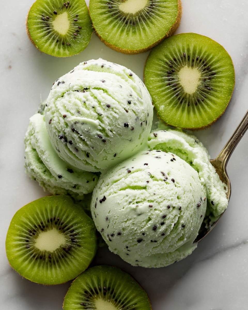 The image shows two scoops of light green kiwi ice cream with small black kiwi seeds spread throughout the smooth, creamy texture. Surrounding the ice cream are slices of fresh kiwi fruit, with bright green flesh and small black seeds around the white center, providing a fresh and natural look. The ice cream and kiwi slices rest on a white marbled surface that adds brightness and contrast to the scene, highlighting the vibrant green colors. A spoon can be seen touching the upper scoop, indicating someone is about to enjoy the dessert. photo taken with an iphone --ar 4:5 --v 7